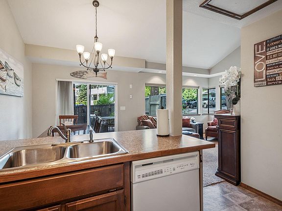 Kitchen overlooks patio and living area.
