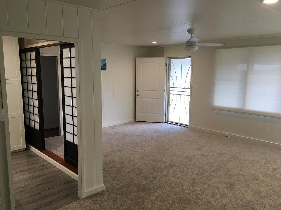 Living room toward front door, security screen door and open shoji door.