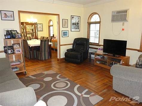 FORMAL LIVING ROOM WITH ARCHED ANDERSEN WINDOWS...