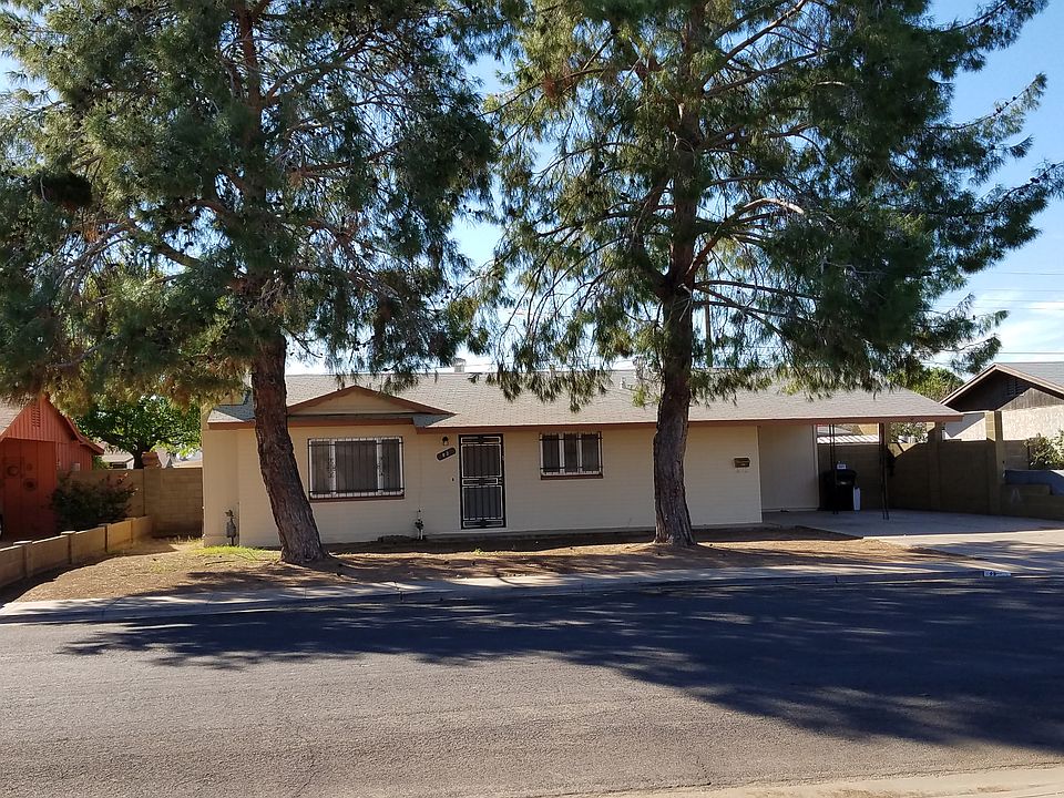 Front of house with pine trees
