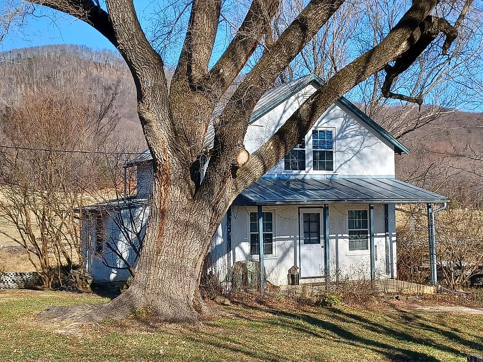 View of farm cottage in February, with Pigeon Top Mountain behind it.