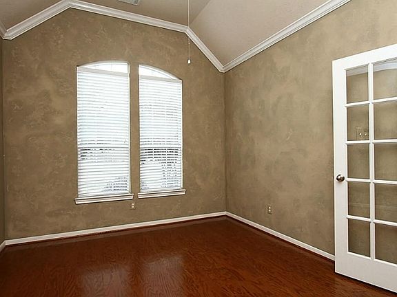 This is such an elegant study.  Gorgeous hardwood floors and French doors.