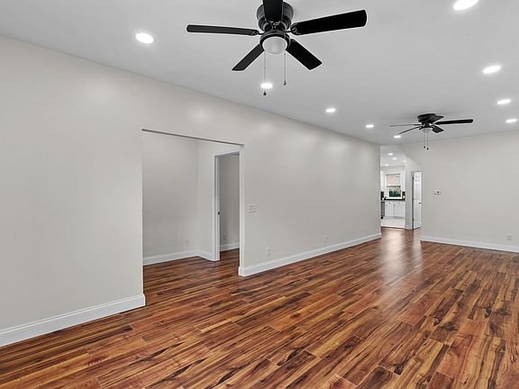 Living Room with two ceiling fans and recessed lights.