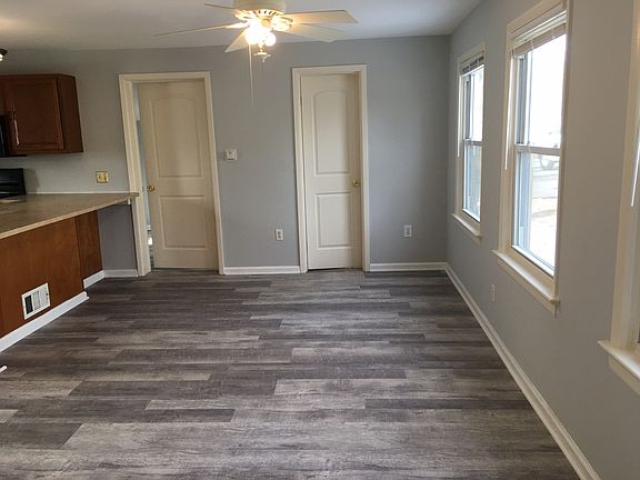 Living room with eat-at-counter on the left. Small door is bathroom and other door is to main bedroom