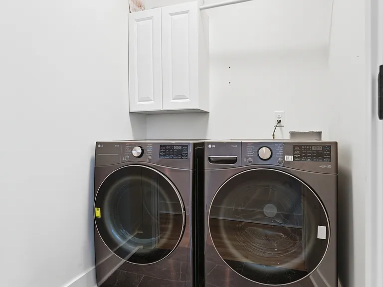 Washer/ dryer room with washer/dryer to remain.