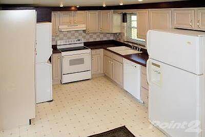 Recessed lighting, white washed oak cabientry, tiled backsplash plus all the applicances are included in this remodeled kitchen, even the stackable washer and dryer.