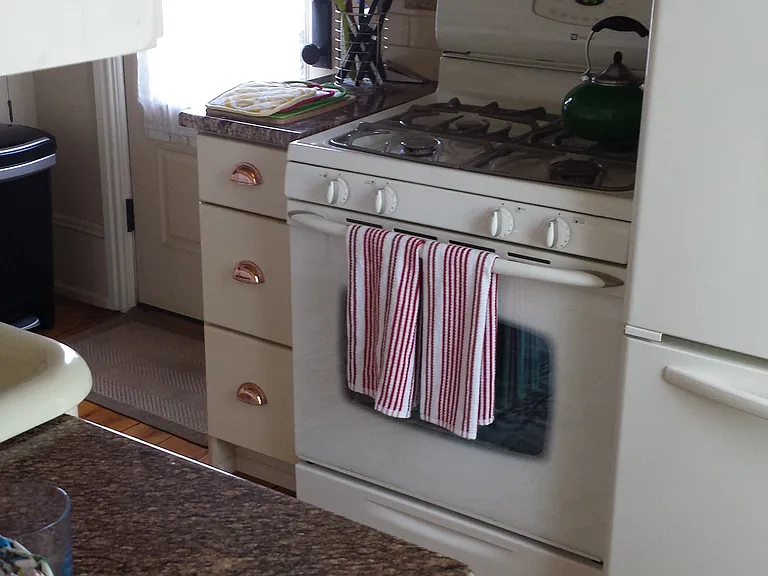 Gas stove with microwave on top