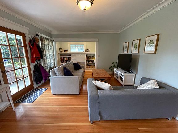Living room with built ins and some original windows.