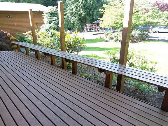 "Covered Front Porch with Built-in Bench Welcomes you to this Spectacular Waterfront Home!"