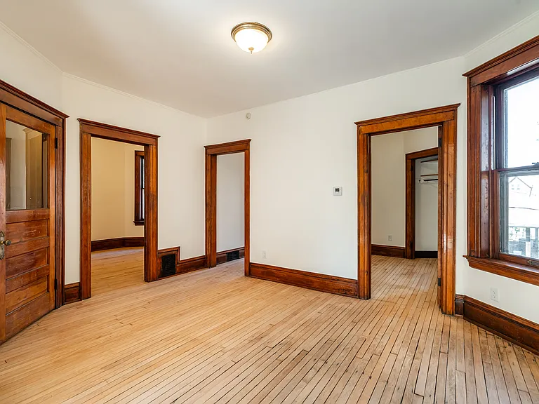 Dining room. 2nd bedroom is through door on right. 3rd bedroom is through 2nd door from left. Front stairway is through door at left.