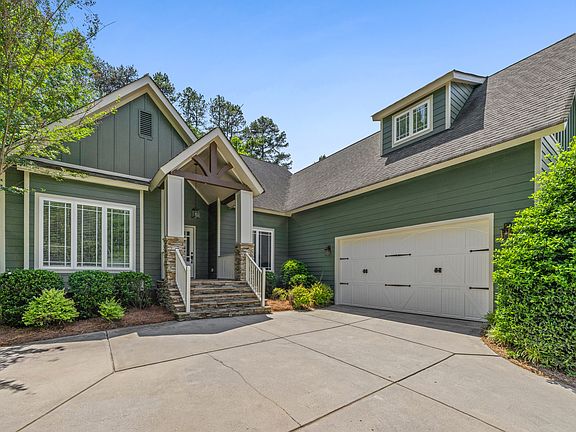 Home features craftsman architecture, natural stone patios, gable beams, carriage style garage door, and mature landscaping all on 0.6 acres. Brand new exterior paint.