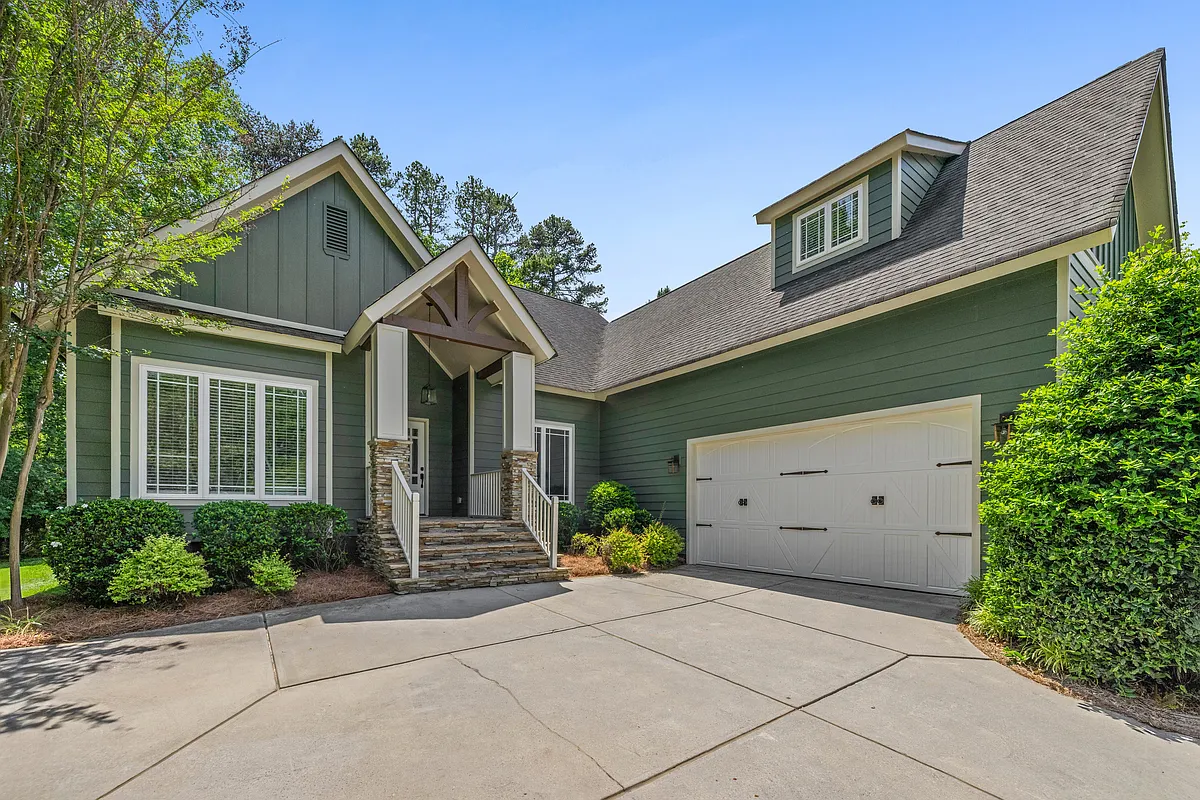 Home features craftsman architecture, natural stone patios, gable beams, carriage style garage door, and mature landscaping all on 0.6 acres. Brand new exterior paint. - 17521 Green Hill Rd
