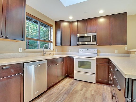 Fully renovated kitchen features updated cabinetry, appliances, laminate flooring & counter tops.