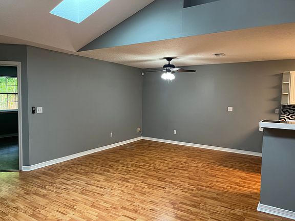 To the right of the entry way is the kitchen, living/dining area to the left of the kitchen. You can also see the door going into the master bedroom in this photo. Skylights provide beautiful, natural light!