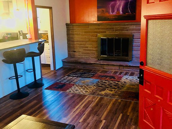 Entry, gas fireplace, living room, sitting bar, and laminate floors throughout