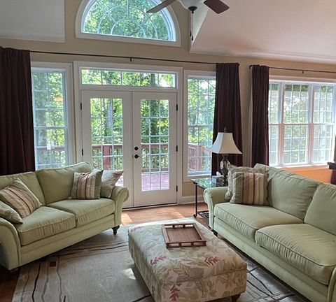 Open floor plan. Living room with cathedral ceilings, ceiling fan.