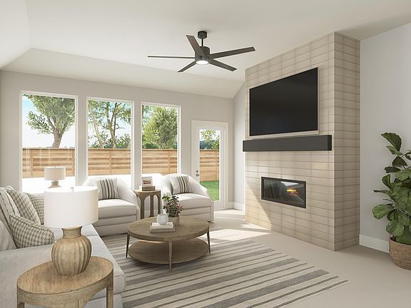 A cozy and well-designed living room with a fireplace, comfortable seating, and large windows overlo