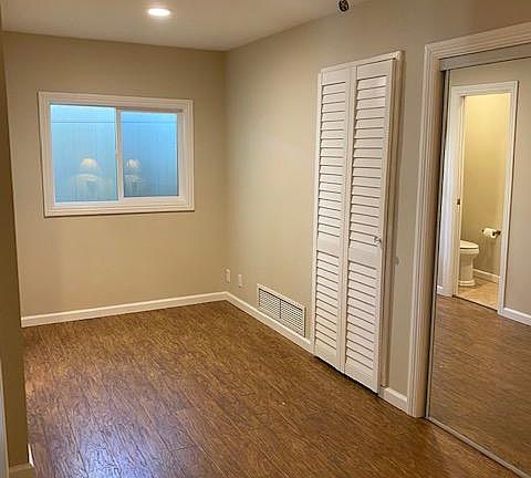 Bedroom with stackable washer and dryer.