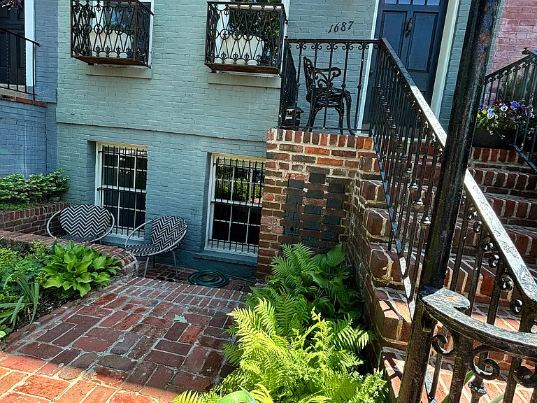 Separate English basement apartment entrance walkway. Apartment front door is located under the main upstairs landing.