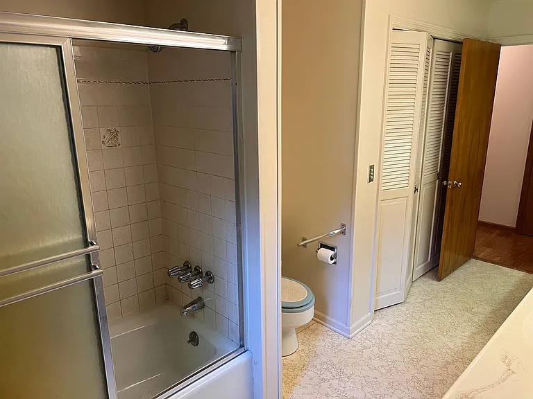 Hall Bath showing bath / shower & large linen closet