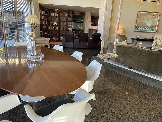 8' fine wood Saarinen table with 8 swivel Saarinen chairs for larger dining.