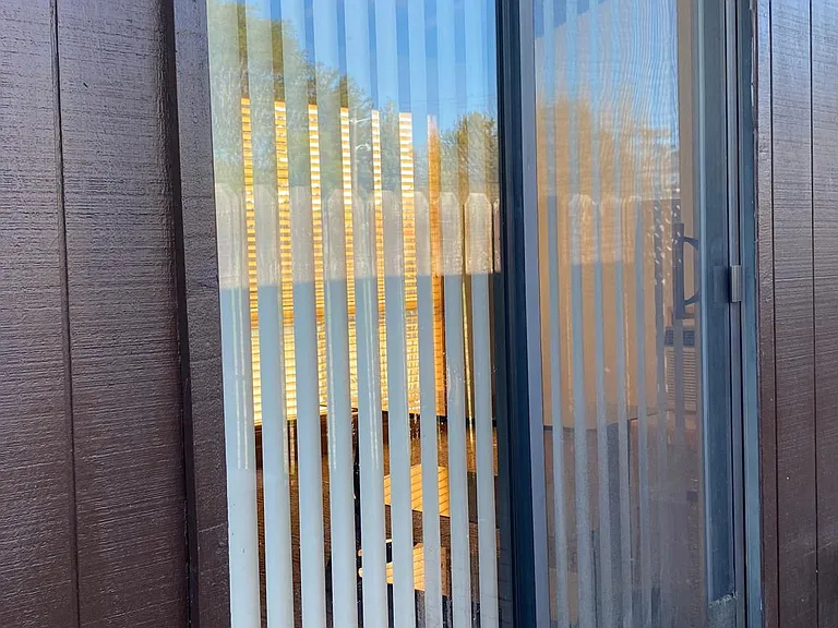 Outside fenced patio area with glass door entrance.