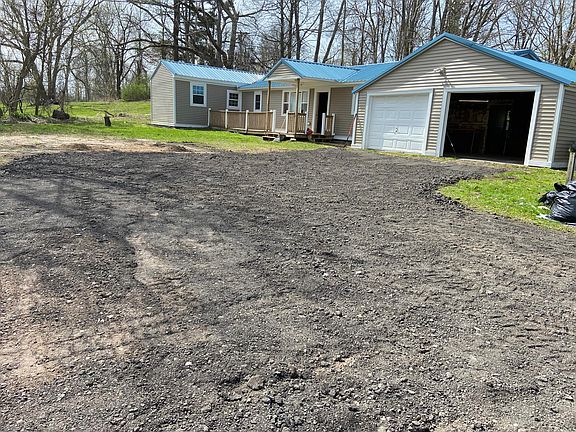 Photo of house before the snow season. With spacious garage.