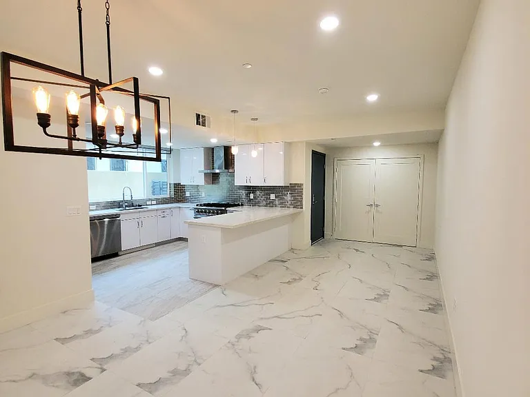Dining area looking to kitchen and foyer