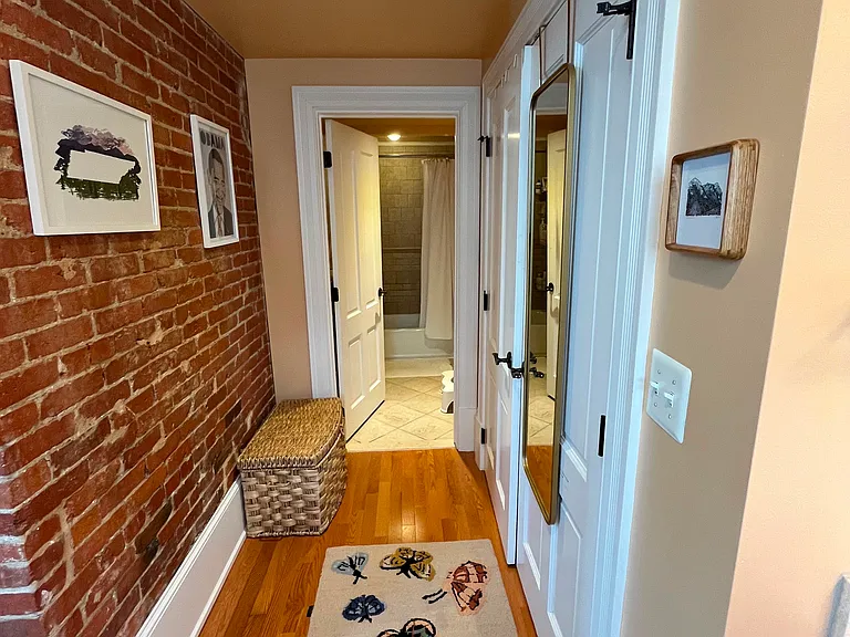 Large closets in hallway. Space enough for a bureau in Master suite hallway leading to bath/toilet room.