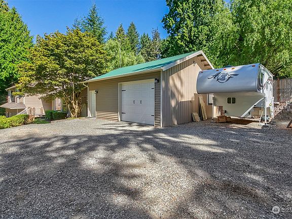 Home is wrapped with durable cedar siding and the shop has wood siding up from and and metal on the sides and back.>