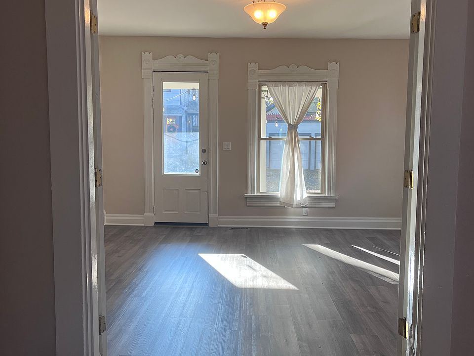 In the middle room looking through French doors to front door.