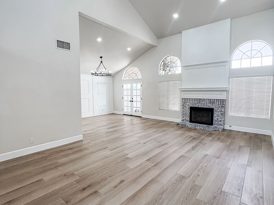 Living Room with vaulted ceilings, gas fireplace, recess lighting, and formal dining area.
