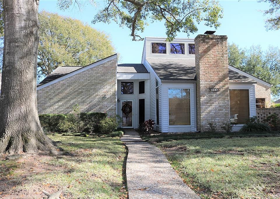 Here is your new home! Beautiful front yard with view of established trees from large windows in Den.