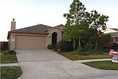 Elevated covered entryway and 2 car garage with automatic garage opener.