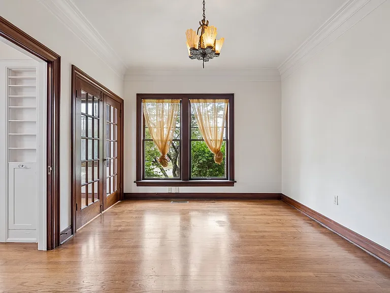 Formal dining room. Double doors on far left open to dining nook. Near left door to kitchen