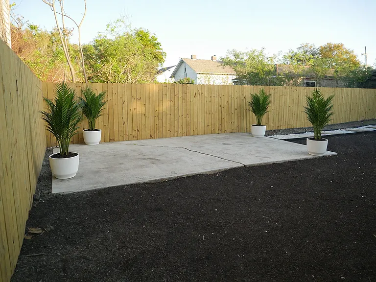 Concrete patio area ideal for outdoor seating, grilling, or entertaining