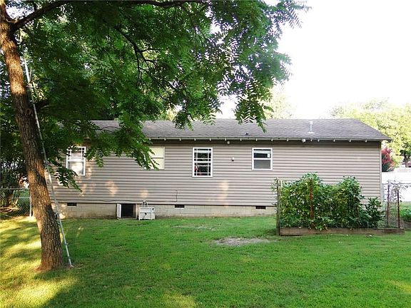 Back of home...level lot.  Vinyl windows.