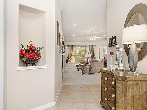 Step inside to a bright open foyer with decorative niche and extended tile floor! Study sits to the left.
