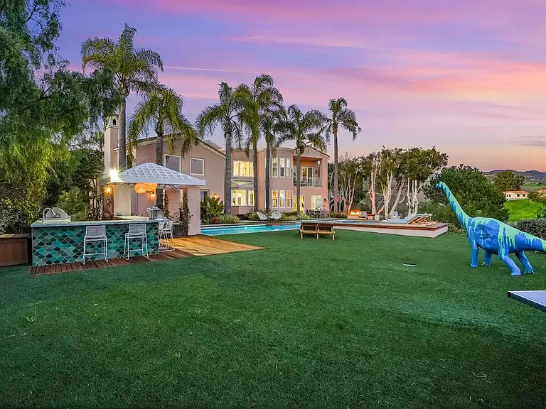 Enjoy a drink at the outdoor bar with a sunset backdrop.