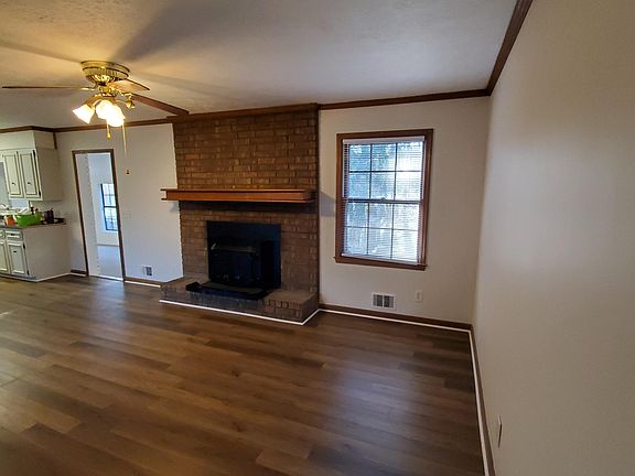 Living room with wood burning stove and new vinyl plank flooring.