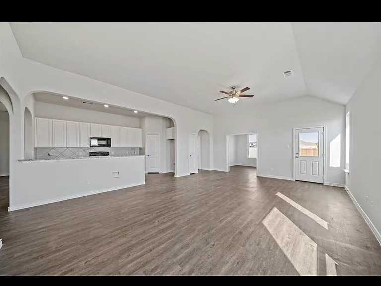 Galley kitchen and bar, open concept living and dining space