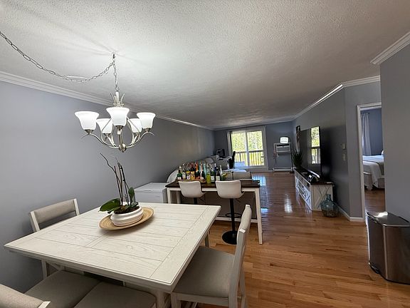 Living and Dinning Room with Slider to Balcony overlooking the Golf Course