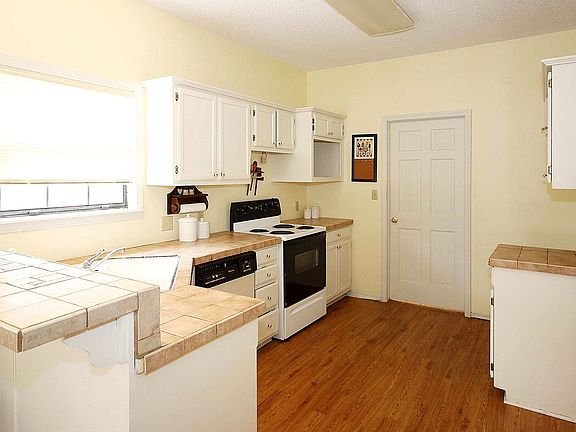 Large kitchen with upgraded tile countertop.