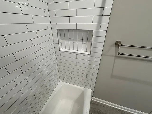 Tiled niche in Main Level Hall Bathroom with towel holder