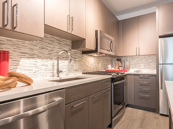 Contemporary stone counters, tile backsplashes and custom cabinetry in our kitchens.