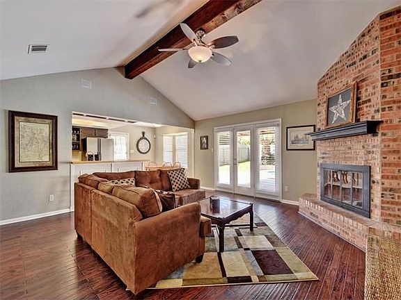 Step inside and stay away in this charming space!  Youll love the warm feel the hardwood floors, brick fireplace and ceiling beam creates!