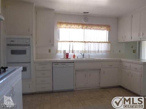Happy kitchen ..plenty of cabinets..window over sink allows view to rear yard. Also kitchen eating.