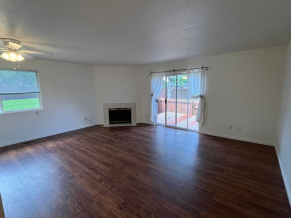 great room with gas fireplace and new flooring