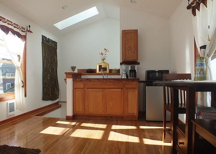 Kitchenette, includes microwave, toaster, hot plate but no stove yet. New larger frig.