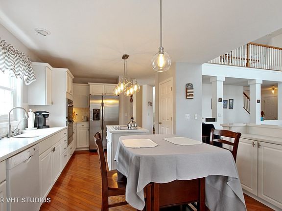 Kitchen with brand new quartz countertops; new light fixtures; hardwood floors